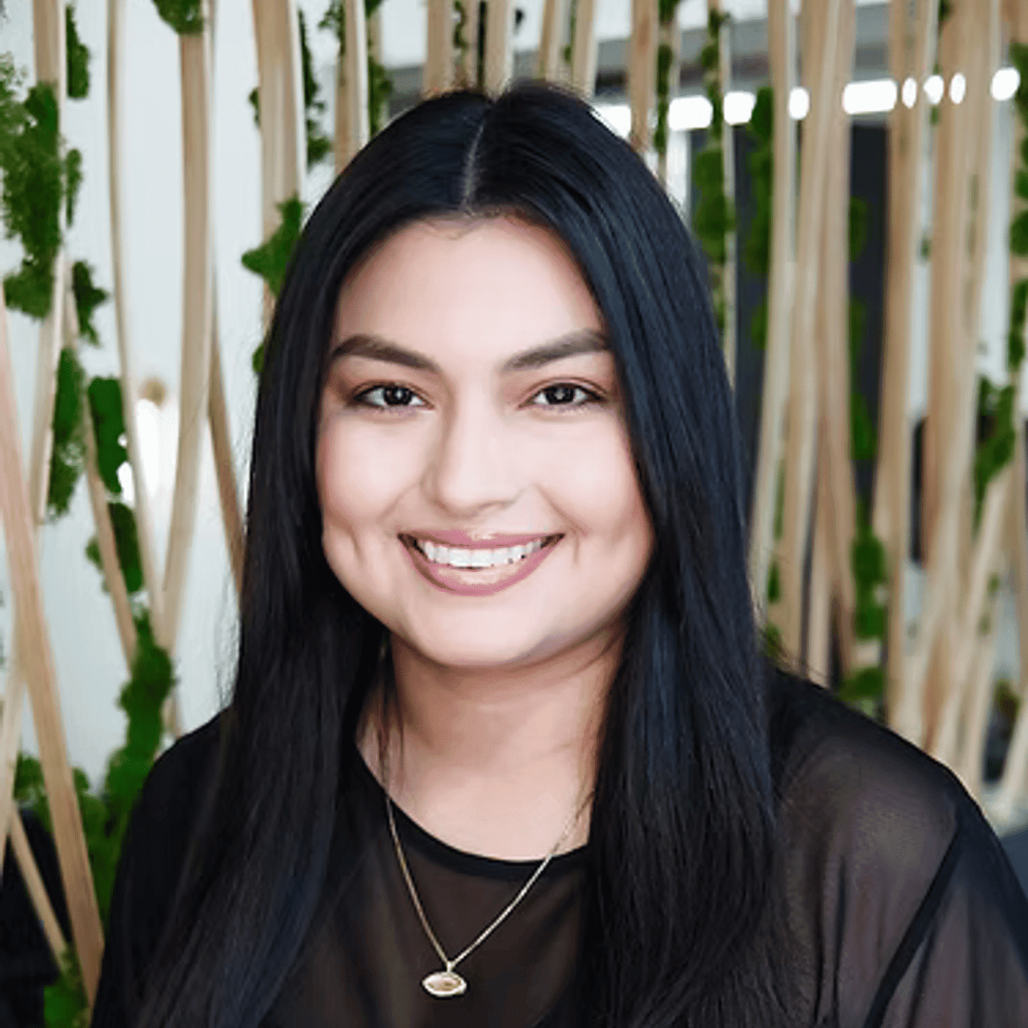 Portrait of Selena, a professional stylist at Tangles Salon, showcasing their expertise and style.