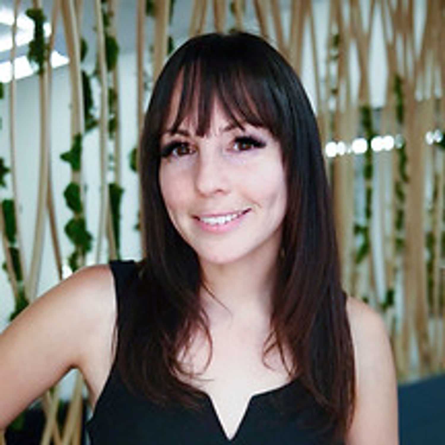 Portrait of Bri, a professional stylist at Tangles Salon, showcasing their expertise and style.