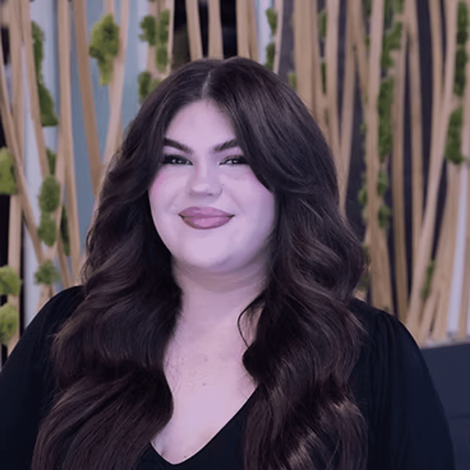 Portrait of Sarah ​, a professional stylist at Tangles Salon, showcasing their expertise and style.