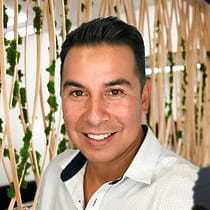Portrait of Raul, a professional stylist at Tangles Salon, showcasing their expertise and style.