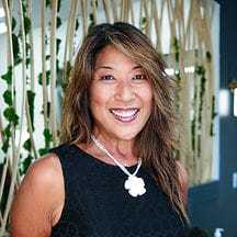 Portrait of Lyn, a professional stylist at Tangles Salon, showcasing their expertise and style.